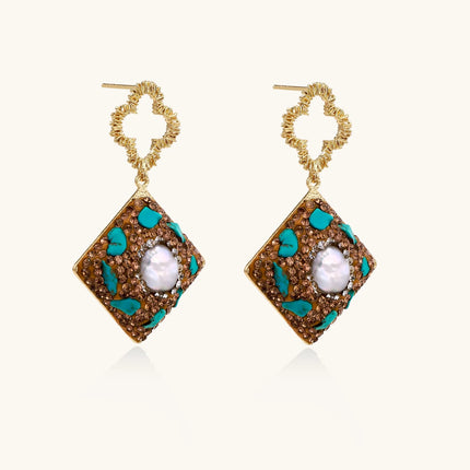 Gold-plated drop earrings with quatrefoil studs, diamond-shaped pendants featuring baroque pearls, turquoise stones, and amber crystals