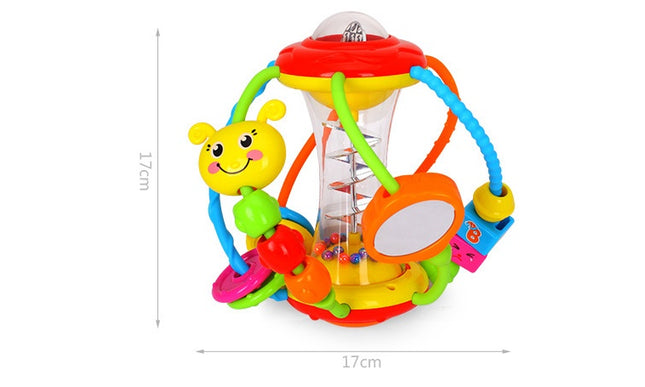 Baby hand holding rattle ball toy