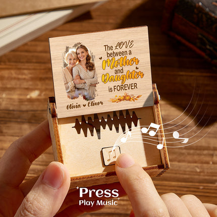 Personalized Mother's Day music box with photo and engraved message, playing music.