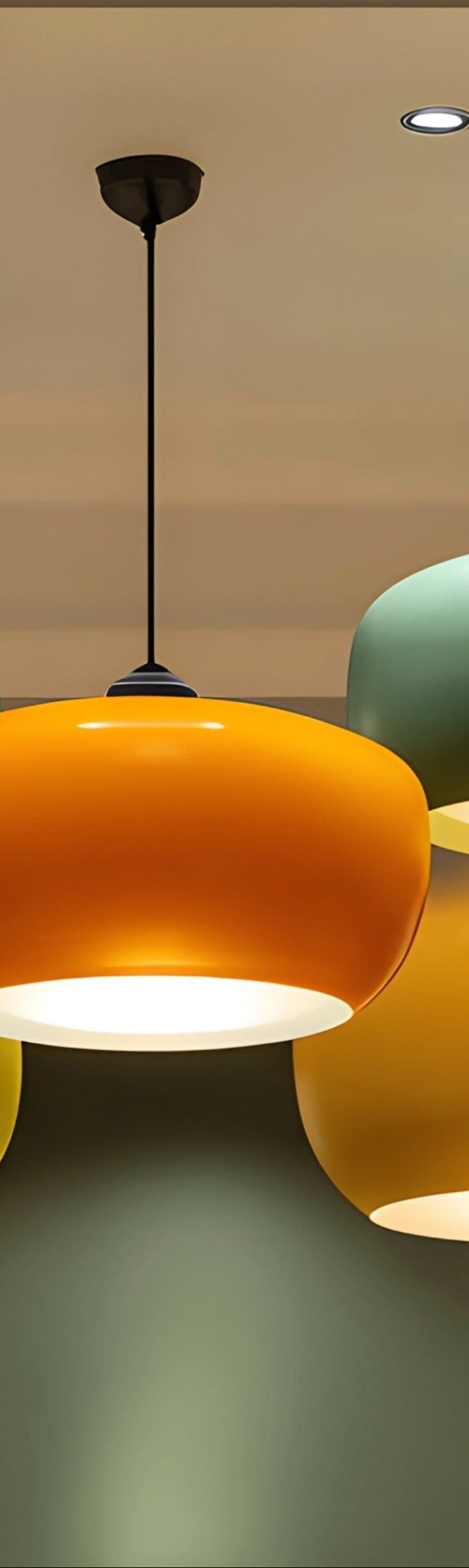 Colorful ceiling lights hanging from a ceiling with a visible brand logo.