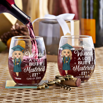 Personalized "I Wined a Lot But I Mastered It" graduation wine glasses, filled with wine, graduation gift.