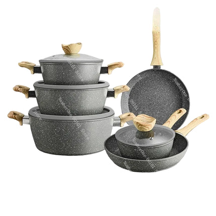 Set of gray cookware with wooden handles on a gray surface