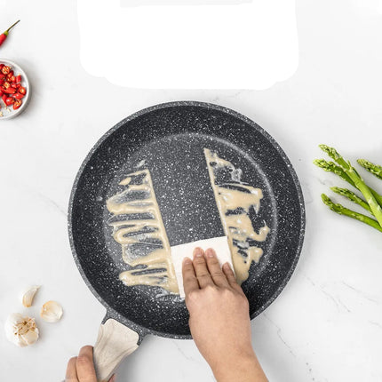 Person cleaning a non-stick frying pan with text on a white background