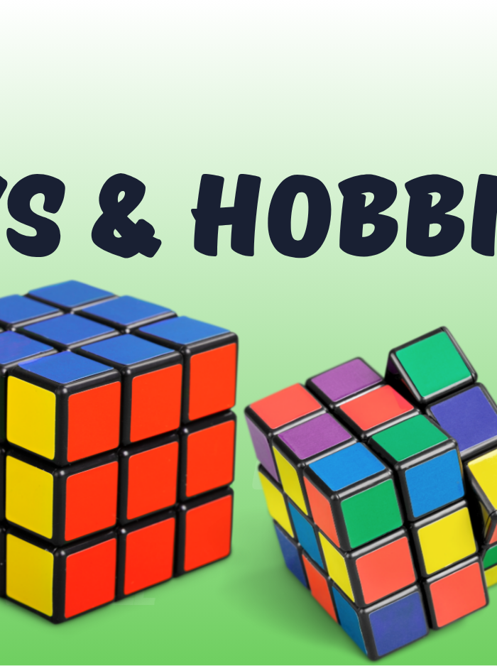 Collection of toys including a toy truck, Rubik's cubes, and building blocks on a green background with 'Toys & Hobbies' text.