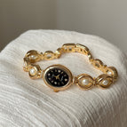 Gold Strap Black Surface